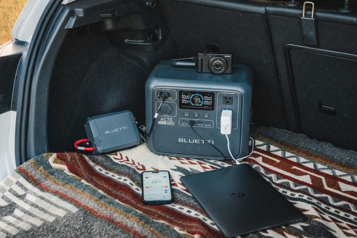 a photo of BLUETTI Charger 1 connected to a BLUETTI portable power station in the back of a SUV