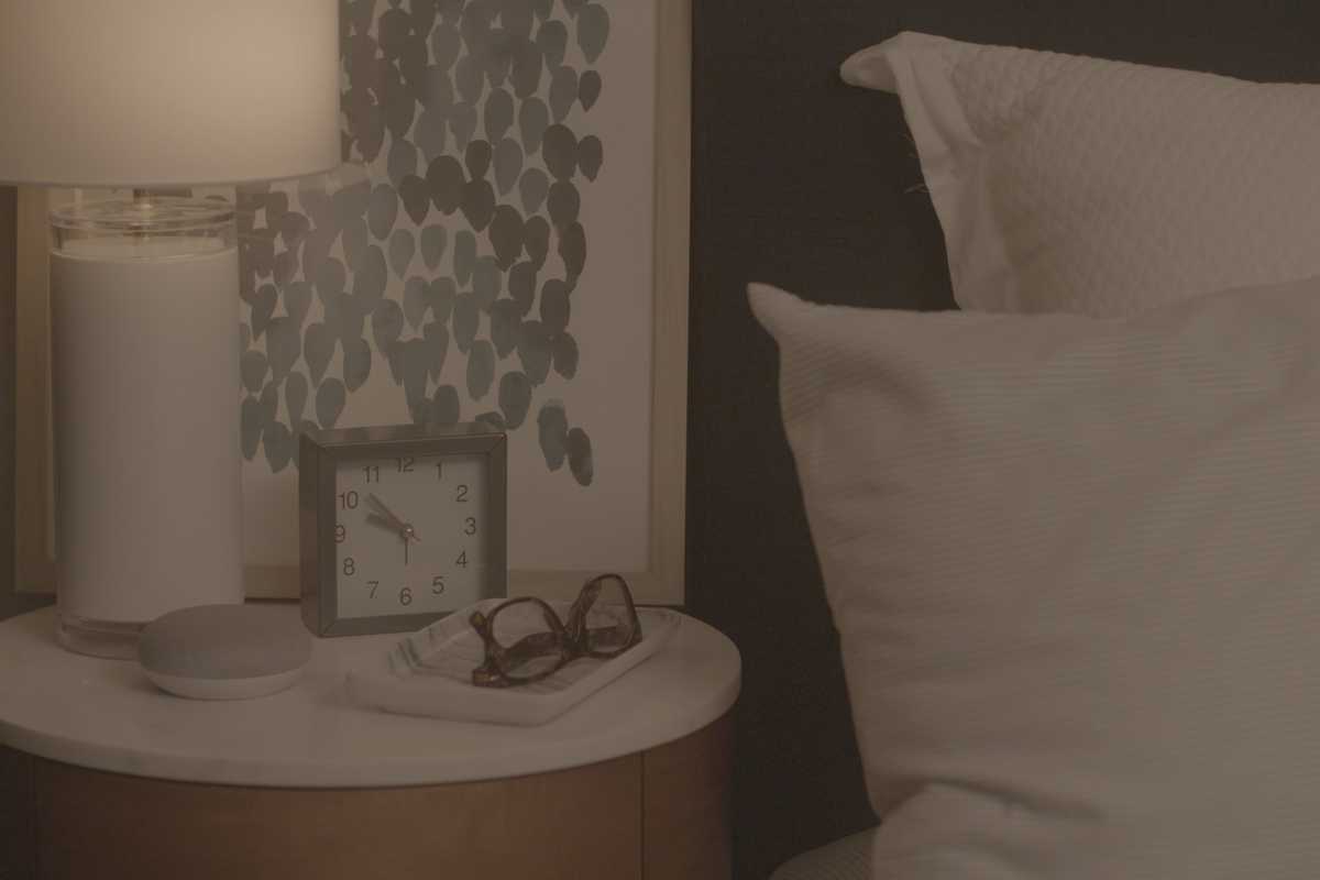 a photo of CbyGE bulbs in a lamp on a nightstand.