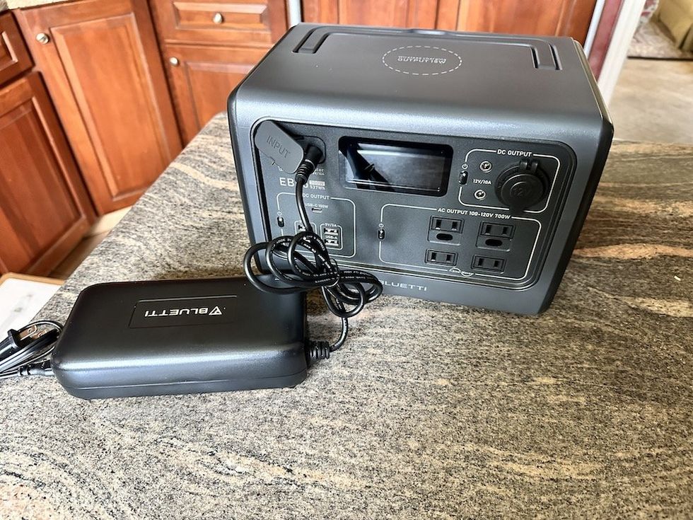 a photo of charging BLUETTI EB55 Portable Power Station with standard outlet