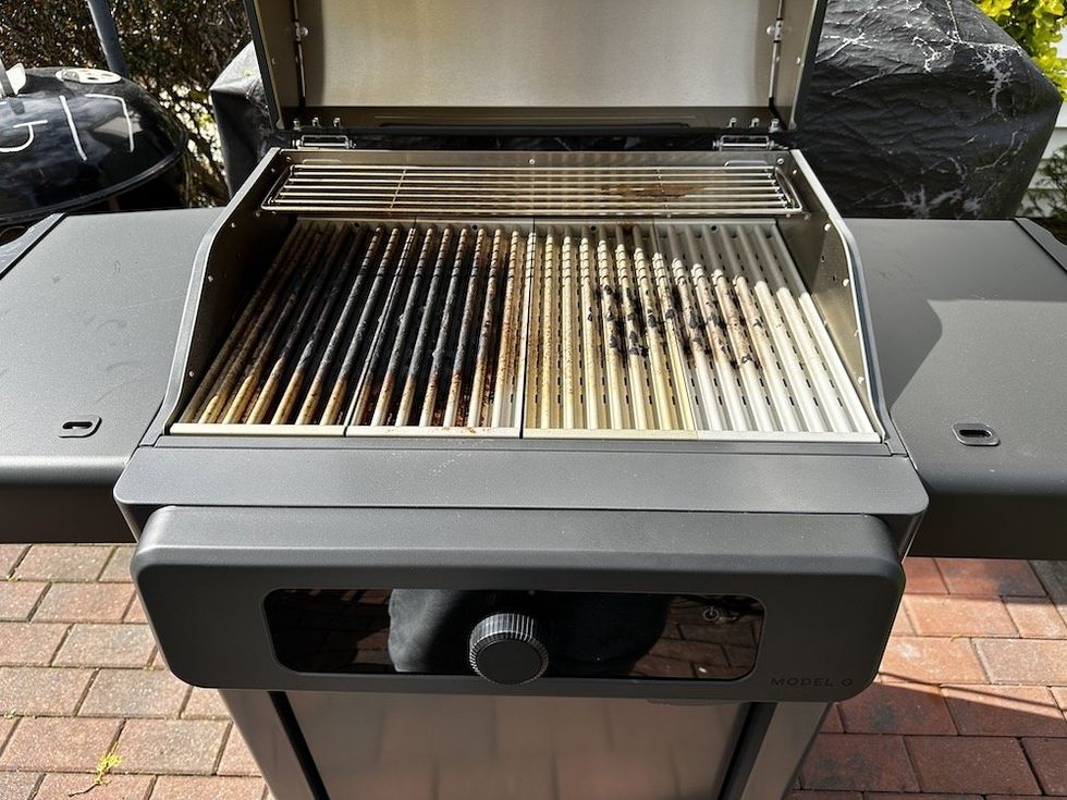 a photo of Current Model G grill after smartclean mode. It shows the grates are still brown from cooking.