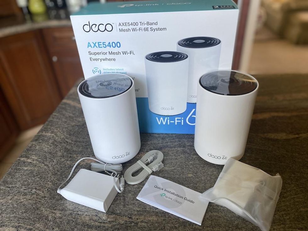 a photo of Deco axe5400 Tri-Band Mesh Wi-Fi 6e system unboxed.