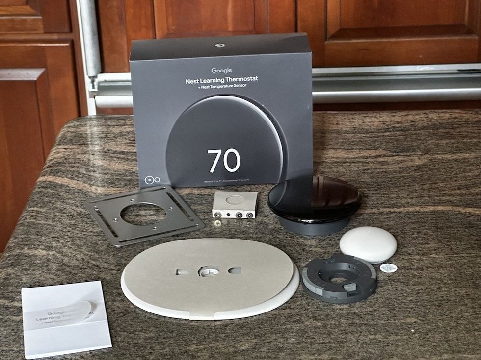 a photo of Google Nest Learning Thermostat (4th Gen) and Nest Temperature Sensor (2nd Gen) unboxed