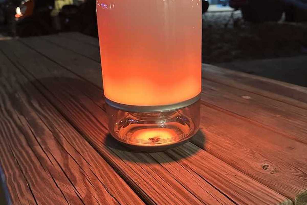 a photo of Govee Table Lamp 2 Pro on a picnic table at night at the beach.