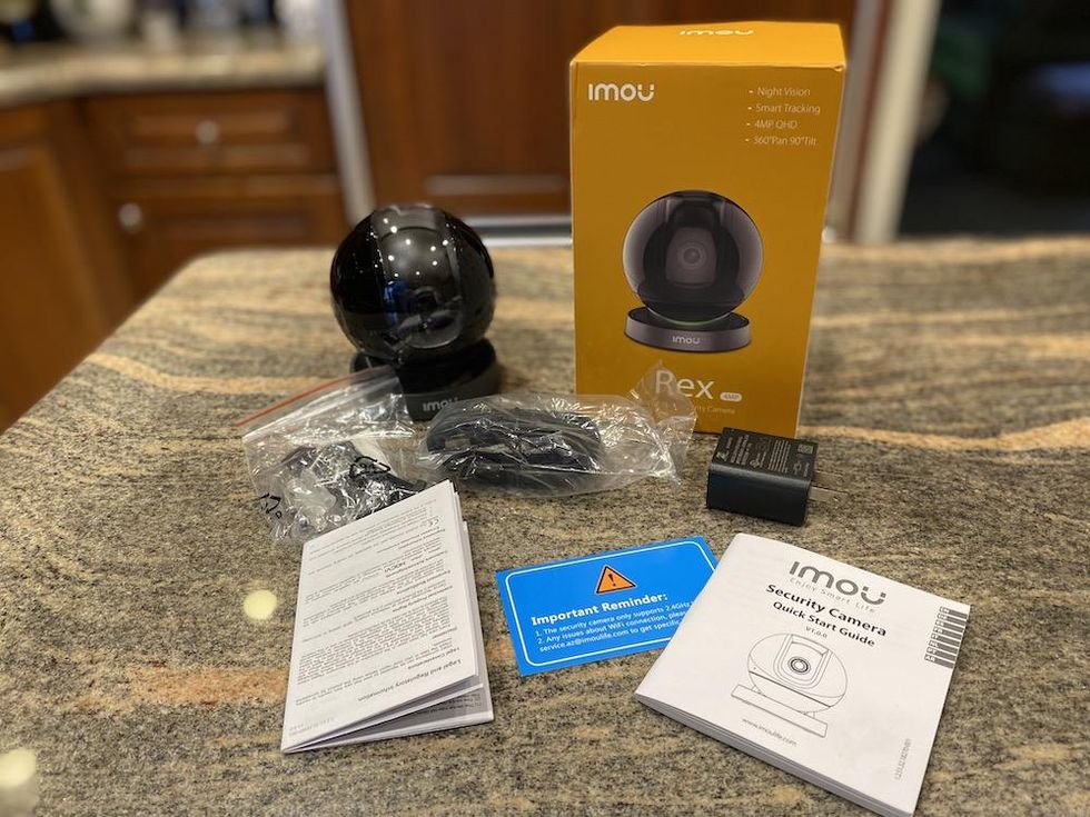 a photo of Imou Rex 4MP Pan and Tilt Security camera with AI unboxed on a countertop