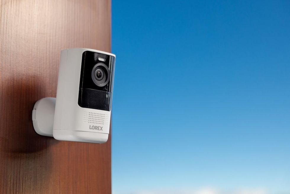 a photo of Lorex 4K Spotlight Battery Camera - white on a wall