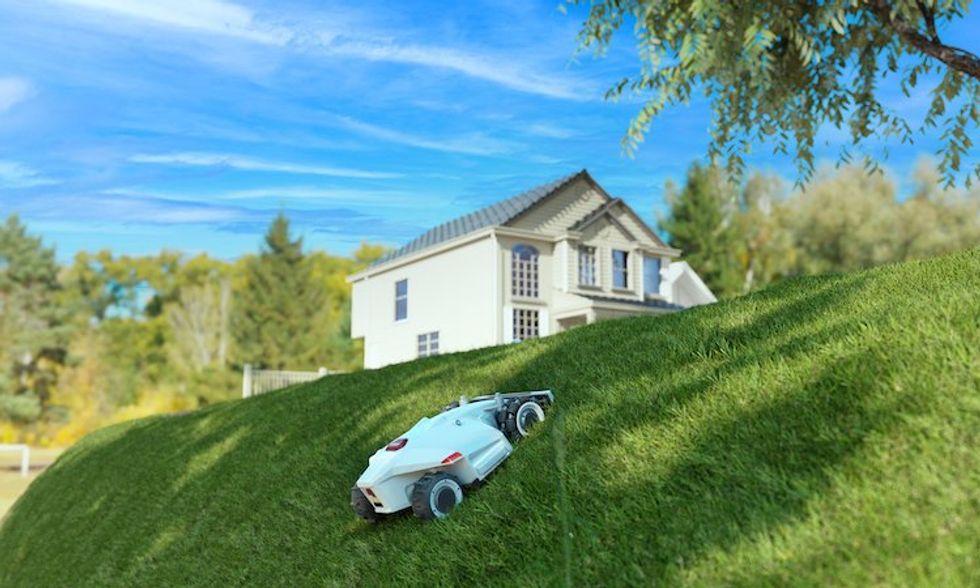 a photo of LUBA Robot Mower going up a hill