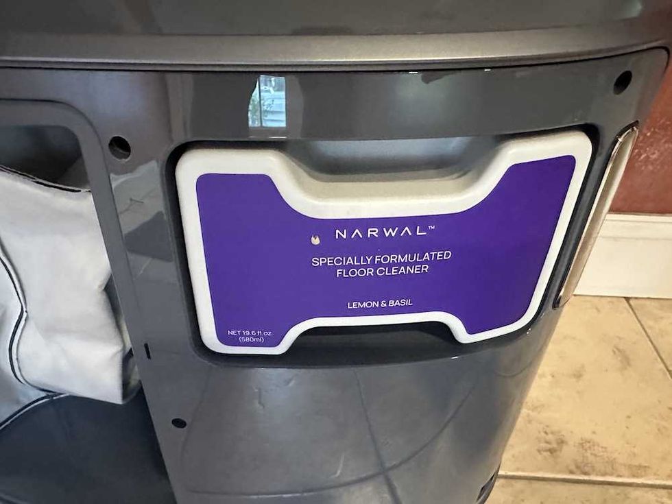 a photo of Narwal floor cleaner inserted into self-emptying station.