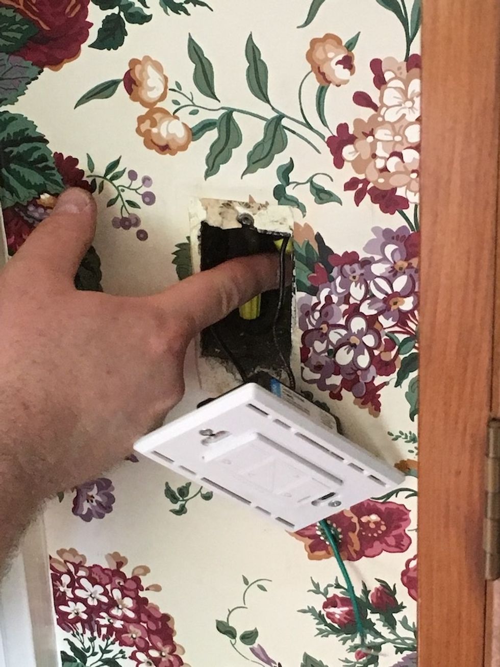 a photo of securing wires in an outlet prior to installing a Lutron smart switch