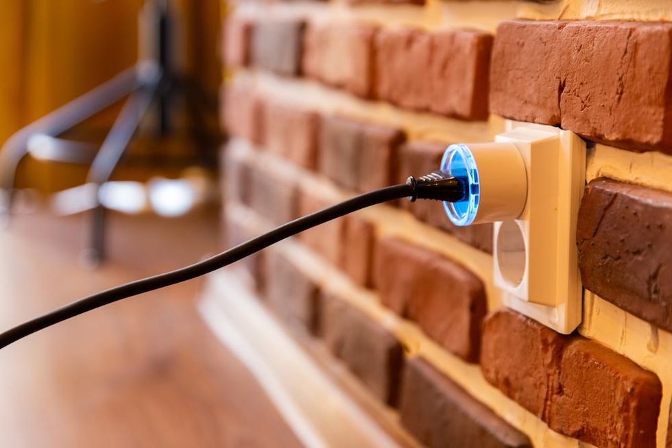 a photo of Shelly Plus Plug (UK) plugged into a wall outlet