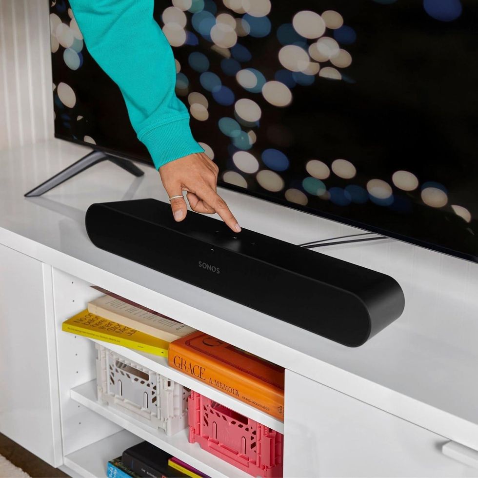 a photo of Sonos Ray soundbar on an entertainment system,.