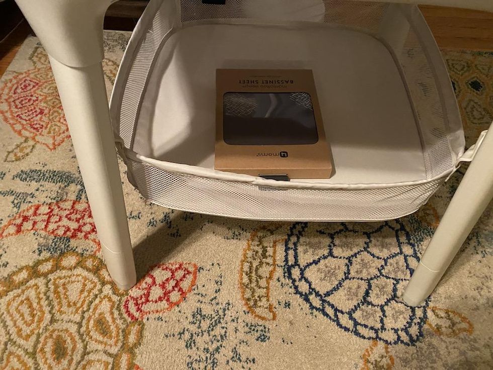 a photo of the bottom shelf of the mamaroo sleep bassinet