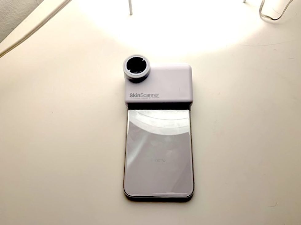 A photo of the Neutrogena Skin Scanner attached to an iPhone X