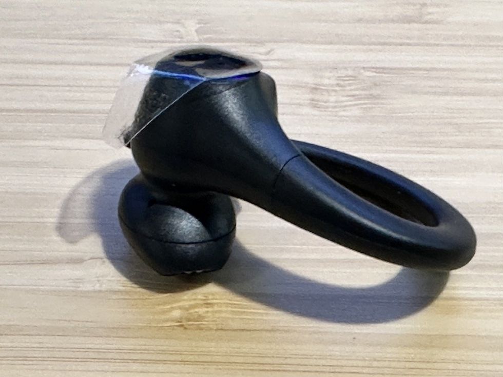 a photo of the SoundPEATS Wings2 wireless earbud on a desktop with protective cover