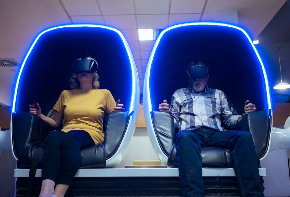 A photo of two people trying VR content in a gaming center