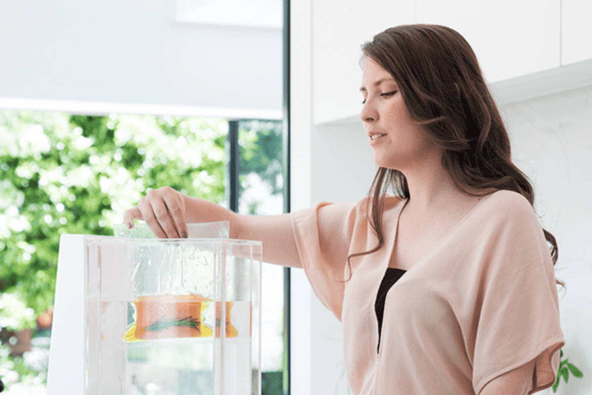 a photo of woman using a food processor