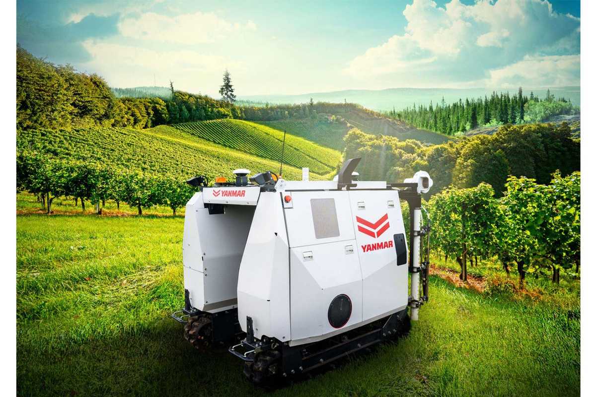 a photo of Yanmar YV01 autonomous smart spraying robot in a vineyard