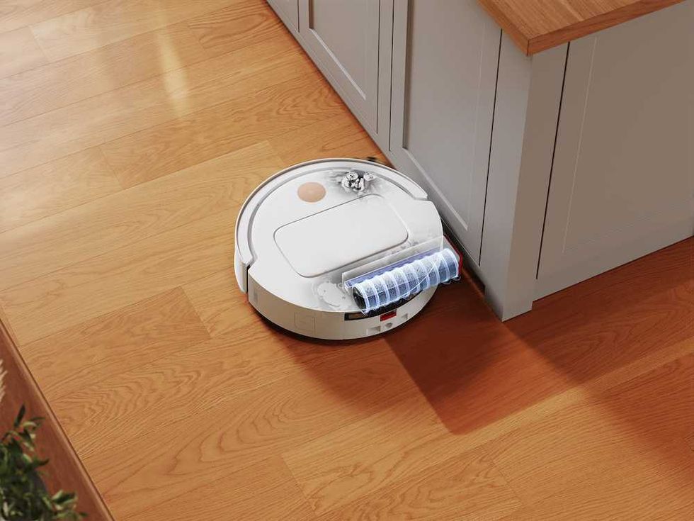 a photo of Yeedi M14 Plus clearning a floor under a cabinet