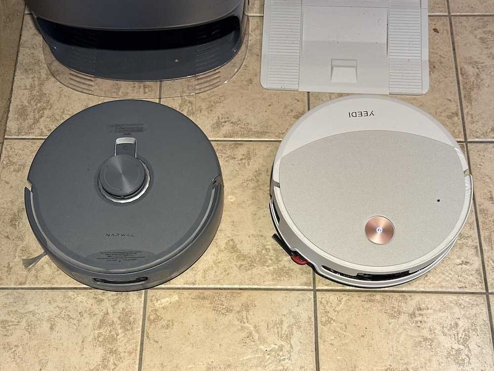a photo of Yeedi M16 Infinity next to Narwal Freo robot vacuum