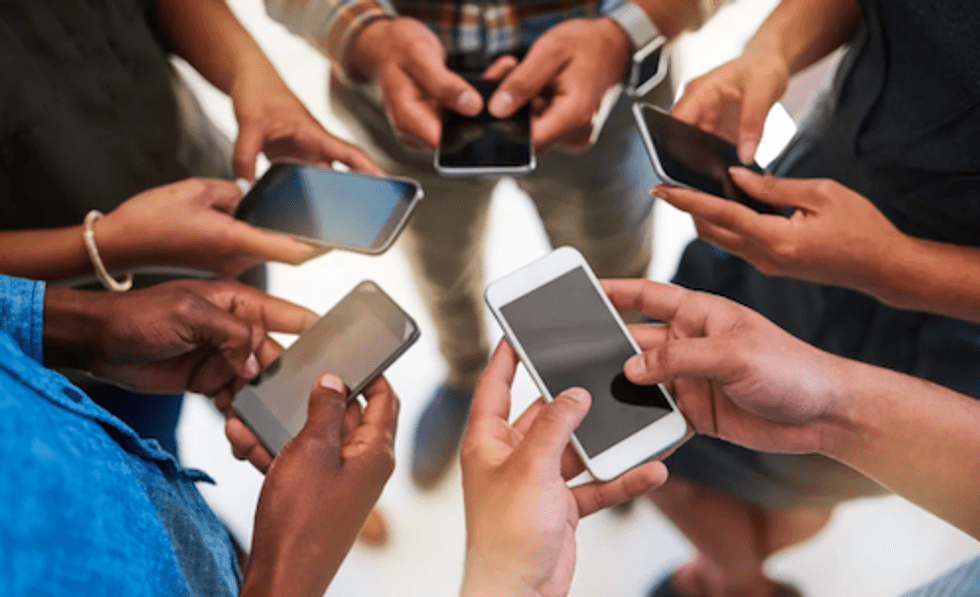 A round of people holding their smartphones