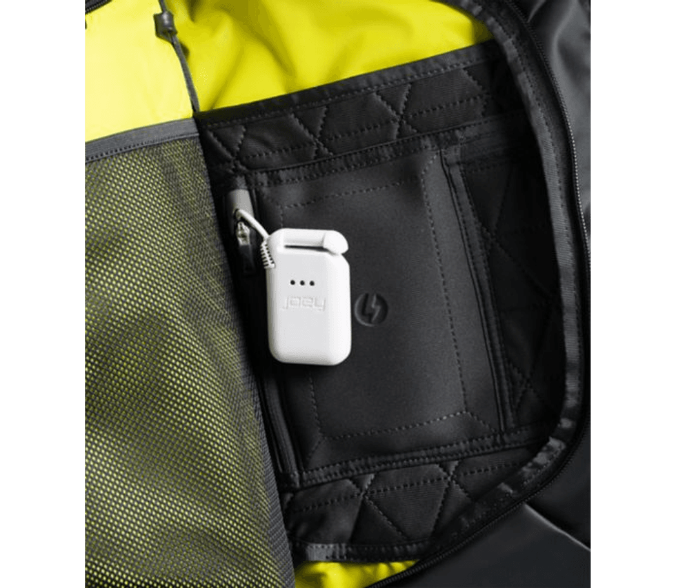 A white battery pack with the word "joey" on it, hanging from inside a loop on abag