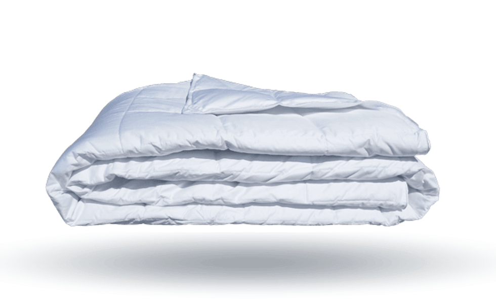 A white, fluffy comfortable folded in quarters and appearing to float in air