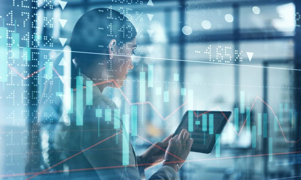 a woman on a tablet with an overlay of stock information