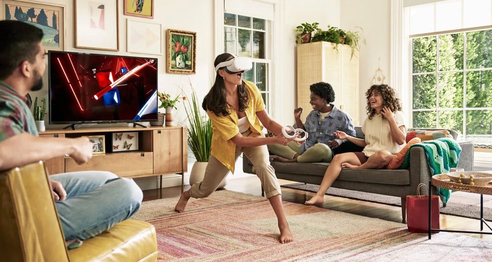 a woman playing a game wearing Meta Quest 2 VR Headset and using controllers