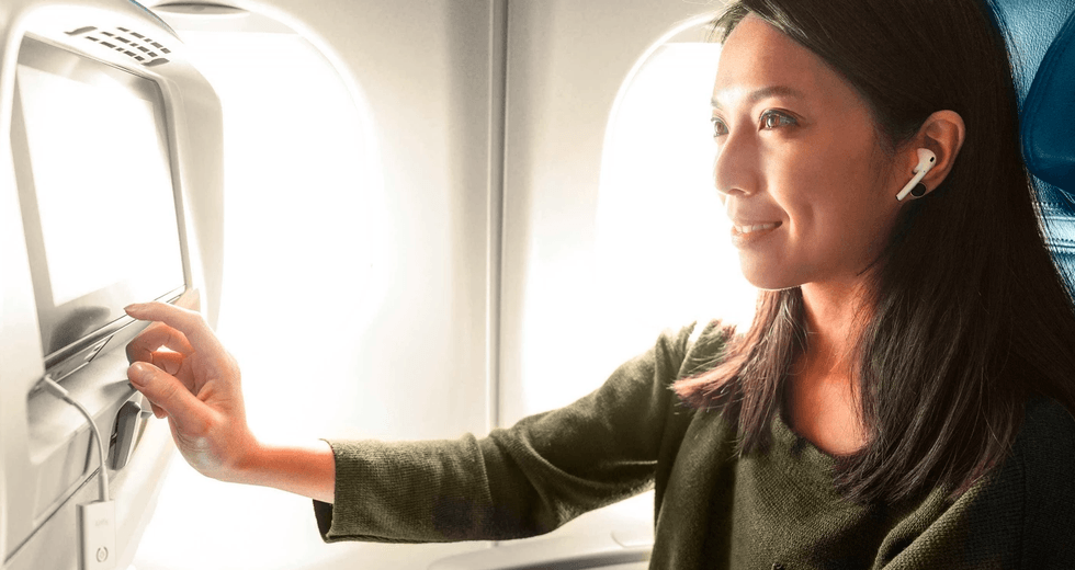 a woman using a Bluetooth Headphone Adapter