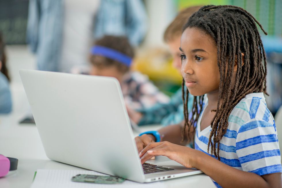 A young girl in front of a computer, with safety controls to help set time limits and even filter sites
