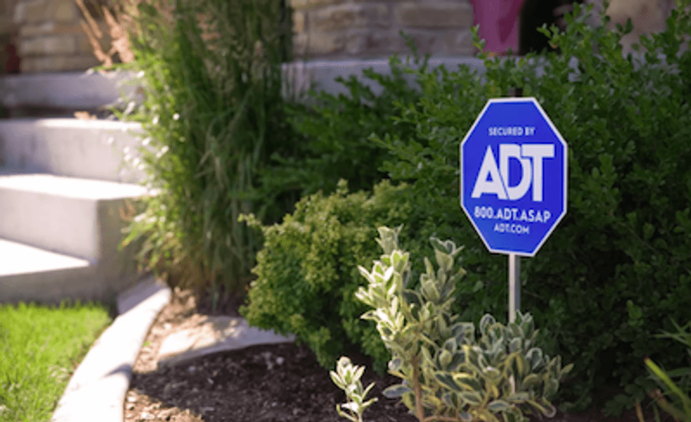 ADT sign on a front lawn