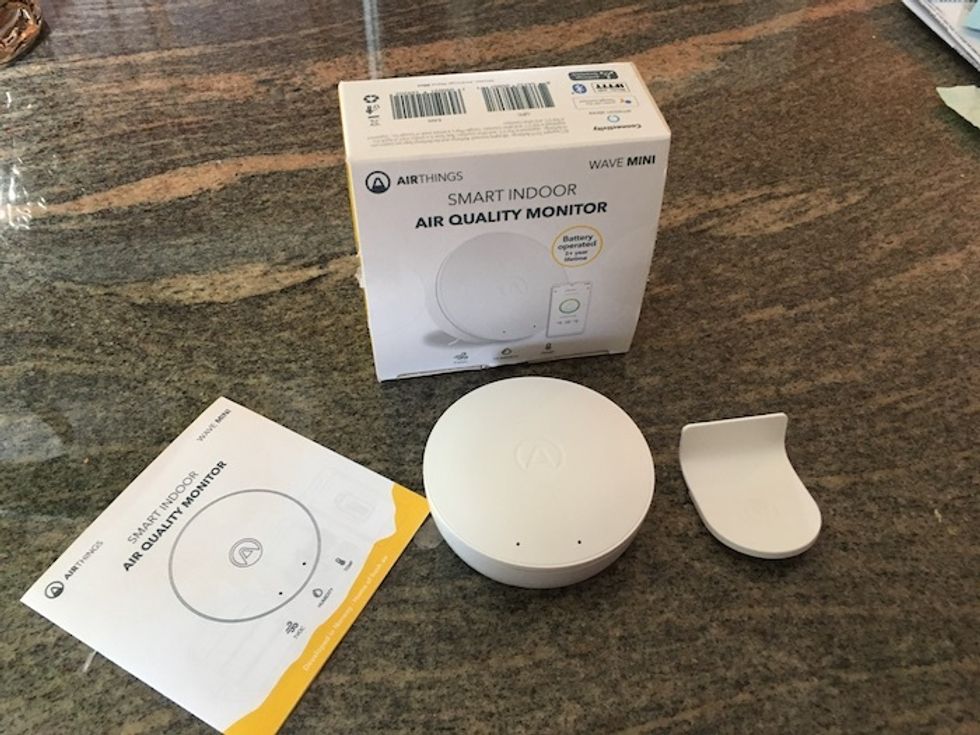 Airthings wave mini on. a counter unboxed.