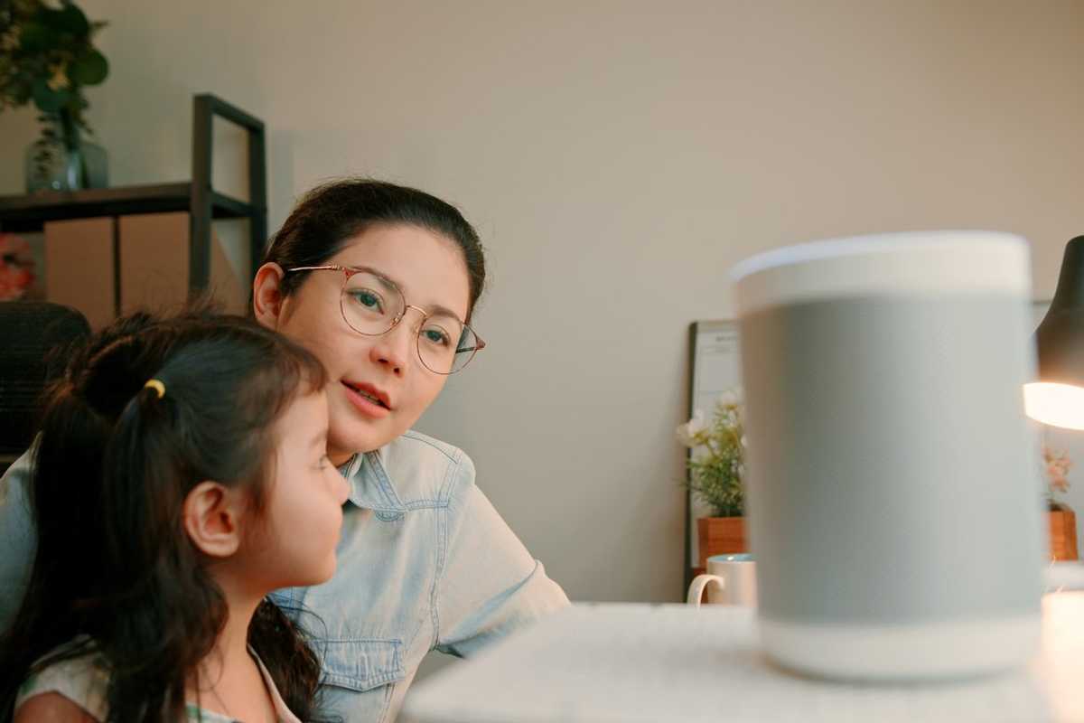 Asian Mother and Daughter Bonding While Working from Home stock photo