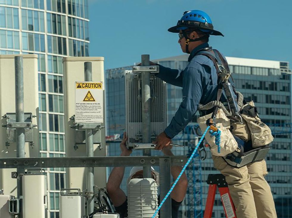 AT&T installer working on installing 5 Gig service on a cell tower
