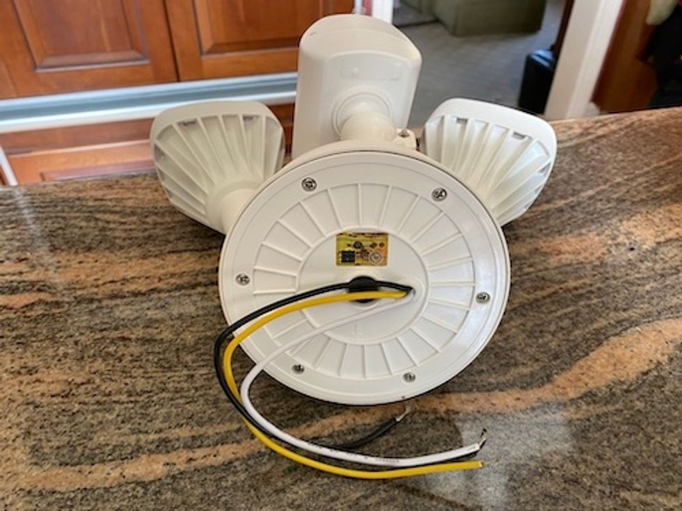 Backside viee of Swann Floodlight Cam sitting on a kitchen counter