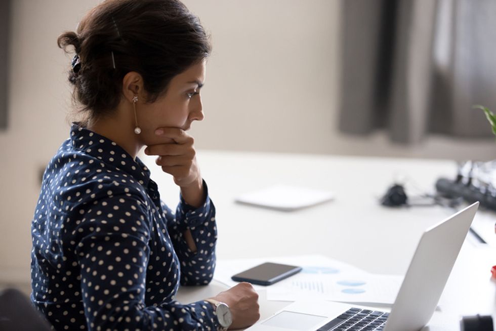 Concentrated serious office worker millennial woman analyzing results