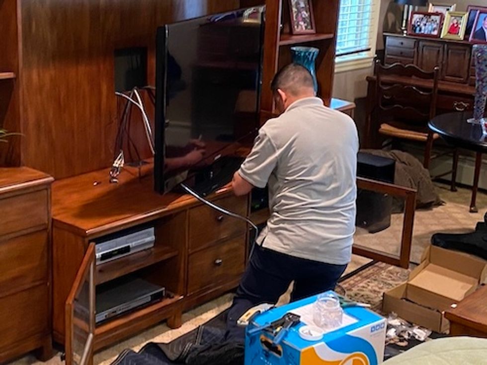 Control4 installer connecting a smart TV to to their system