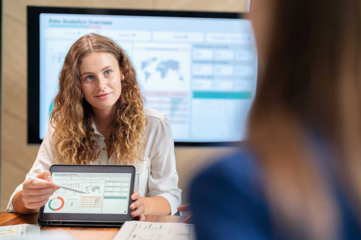 Cultivate members in the organization to share idea to develop the organization to advance. Executive business development team brainstorming and share idea on the new project using digital tablet. Businesswoman manager present the market trend stock photo