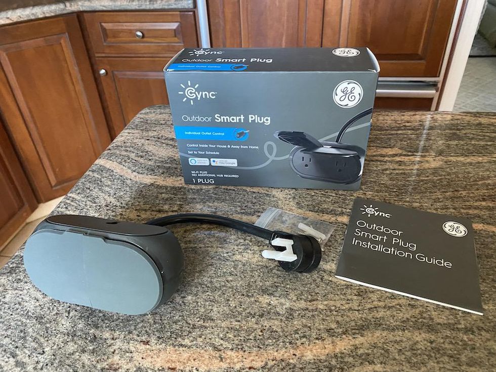 Cync Outdoor Smart Plug unboxed on a countertiop