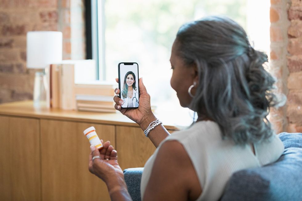 Doctor talks with patient during virtual medical appointment stock photo
