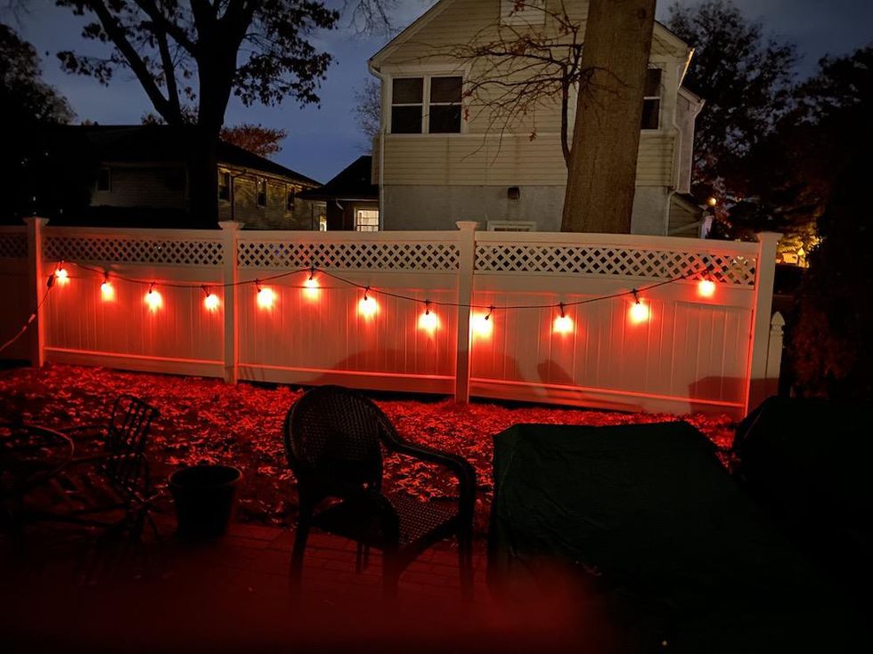 Enbrighten Smart Cafe Lights on a fence.