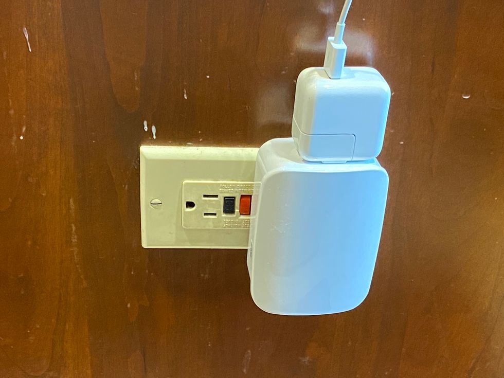 enbrighten Zigbee Plug in smart dimmer plugged into a wall outlet