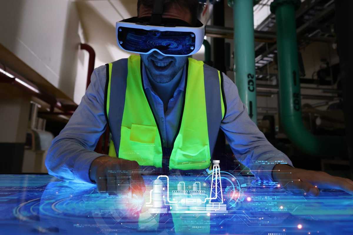 Engineer wearing VR gear to visualize projects in the manufacturing factory on the control panel board stock photo