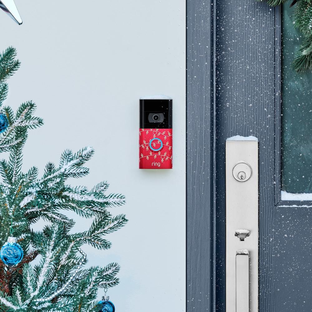 Ring Video Doorbell installed with holiday decorations and snow.
