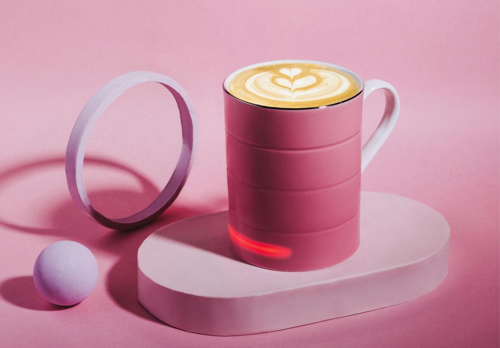 Glowstone Smart Mug 2 on a wireless charger with coffee inside.