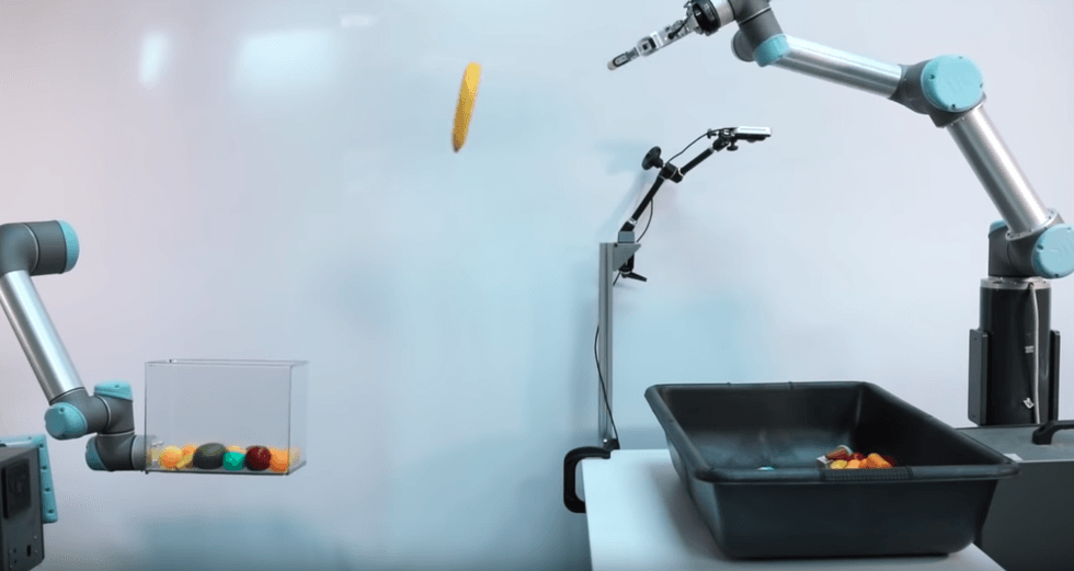 Image showing a Google-built robot throwing an object into a box