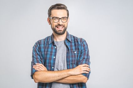 A bearded man with glasses crosses his arms over his chest