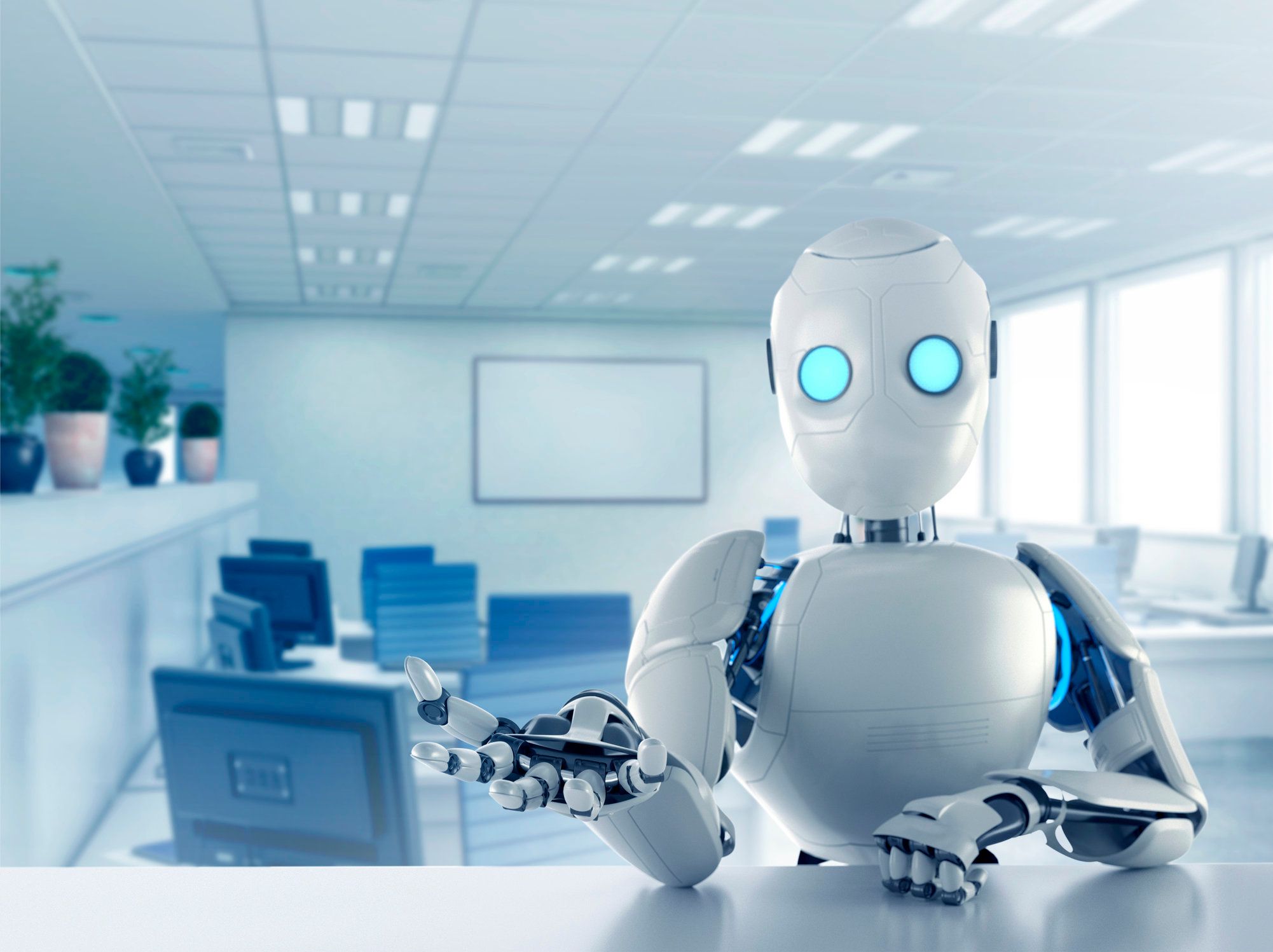 Image of a humanoid robot sat at a desk