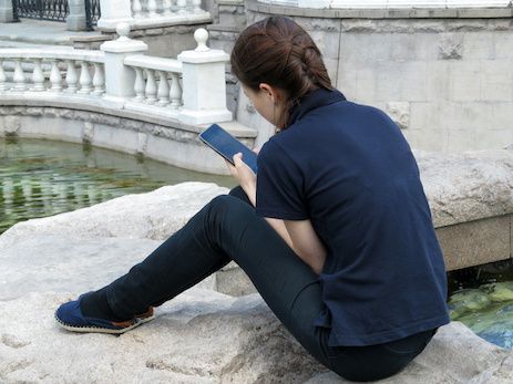 Someone on a smartphone seated near water