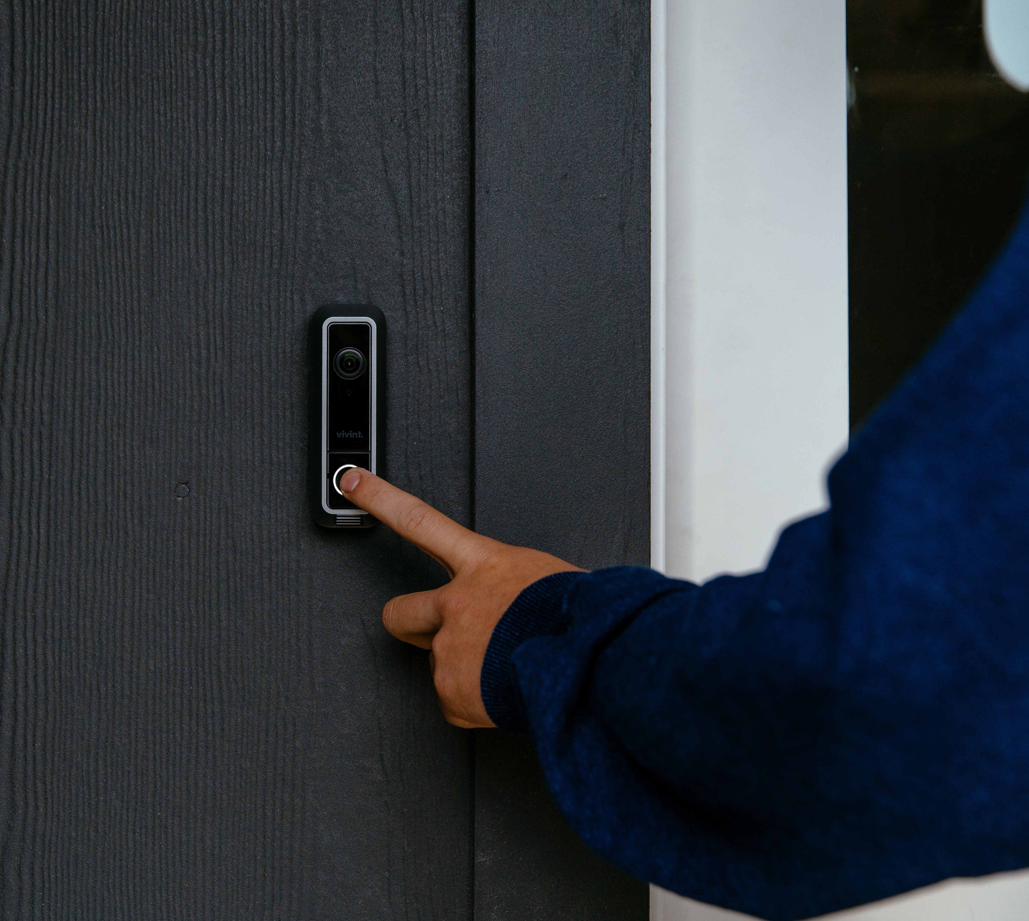 Person pressing Vivint door bell