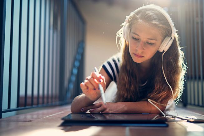 A teen studying on a computer